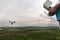 Close up of remote control with tablet for drone in farmer`s hands in field. High technology innovations for increasing productiv