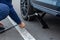 Close up of repair of a flat tire. Man lifts up a car using a jack for wheel replacement, Prague, March, 2020