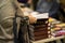 Close-up of respectable woman`s hands with pile of books, bookstore. Education, school, study, reading fiction