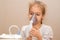 Close up. Respiratory diseases. A 5-year-old child inhales medication using a nebulizer. Therapy of coronavirus