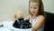 Close-up, in the restaurant, the kid girl served on the table a large bowl, a plate of cooked open blue mussels. child