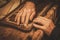 Close-up of restorer hands working with antique decor element in his workshop