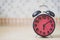 Close up of retro alarm clock on table in the morning