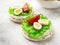 Close up rice cakes with cream cheese and quail eggs with lettuce and tomato on table