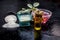 Close up of rice flour face pack on wooden surface in a blue colored glass bowl with some raw rose water,rice flour and Castor oil