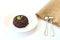 Close up of riceberry rice in white plate and in wooden cup with white background