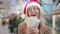 Close up rich Caucasian woman 30s lady wearing red Santa Christmas hat cap and eyeglass happy showing money dollars cash