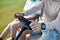 Close up of rich man driving golf cart with hands holding wheel