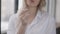 Close-up of ring in female Caucasian hand with blurred unrecognizable young woman sighing at background. Stressed