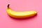 Close up of a ripe banana on background fuscia