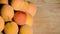 Close up of ripe Blenheim apricots freshly picked, on a wooden table; Blenheim apricots are the most coveted of the apricot