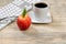 Close up of a ripe red apple for office snack on wooden desktop