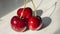 Close-up of ripe red cherries with adjacent sides.