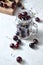 Close-up ripe sweet cherry in the glass cup, on a wooden board on white background with soft focus.