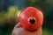 Close-up of a ripe, vibrant pomegranate with glistening water droplets on its surface