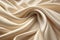 Close-up of rippled beige silk fabric as background