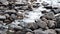 Close up of river stream flowing down over the grey stones. Stock footage. Fast and cold brook with clear water flowing