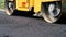 close-up, Road construction works with roller compactor machine and asphalt finisher. Road roller laying fresh asphalt