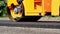 close-up, Road construction works with roller compactor machine and asphalt finisher. Road roller laying fresh asphalt