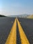 Close up of Road Median Lines and Blurred out Hills