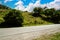 Close up of road in mountainous terrain. Asphalt road going through mountains in summertime.