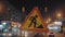 Close-up of a road sign warning drivers about road works. Grunge road traffic sign. Against the background of the lights