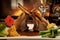 Close up on roast lamb cutlets with vegetables and gravy on a white plate in a restaurant setting