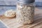 Close up of roasted oats flakes in a jar on table