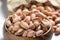 Close-up roasted pistachios in a bamboo bowl. Nuts from Gaziantep-Turkey region