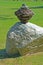 Close up rock cairn sits near an Indian Tee-Pee.