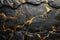 A close up of a rock with intricate gold paint designs, set against a black wall and shimmering gold background