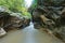 A close up of a rock next to water slow shutter effects in the green forest in Wang Sila Lang, Nan, Thailand