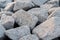 Close up. rock stone breakwater at the pier on the beach