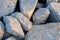 Close up. rock stone breakwater at the pier on the beach