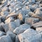 Close up. rock stone breakwater at the pier on the beach