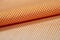 Close up roll orange and white scott pattern fabric of shirt