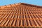 Close-up of the roof ridge made of modern, red, ceramic tiles