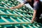 Close-up of a roofer measuring the roof beams