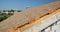 A close-up on roofing construction, roof sheathing with plywood boards, OSB and vapor, damp-proof membrane on roof beams against