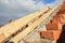 A close-up on a roofing construction, trusses and roof beams installation on a brick wall of the house