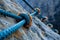 Close Up of Rope on Rock, A dramatic view from the top of a rock climbing wall, ropes and anchors seen in the foreground, AI