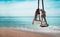 Close up rope Swing plank Benches for relaxation on the sand.