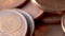 Close-up of Rotating Bronze Euro Coins, Selected Focus, Blurry Background