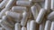 Close-up of rotating capsules, pharmacy background
