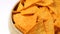 Close up of rotating nacho chips in bowl