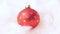Close up of rotating red bauble on cotton wool