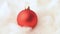 Close up of rotating red bauble on cotton wool