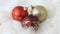 Close up of rotating red and gold baubles on cotton wool