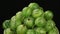 Close-up of rotation of a heap of ripe green gooseberry.