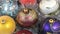 Close-up of a rotation of multi-colored Christmas balls. Christmas background, tinsel.